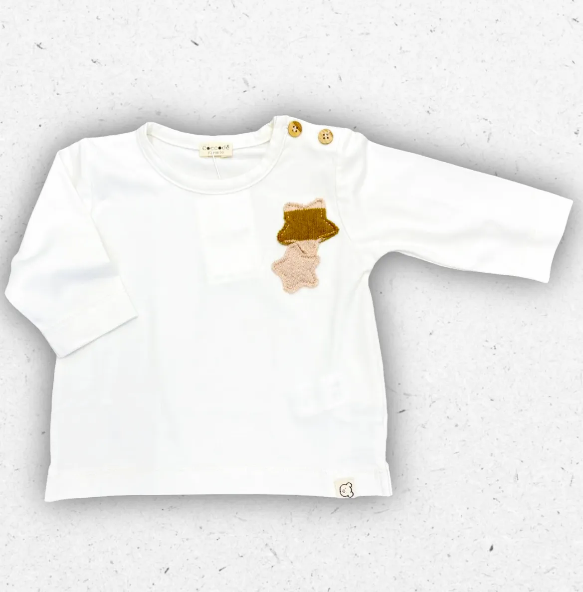 Maglia a manica lunga Coccodè per neonata, colore panna. Realizzata in morbido tessuto con applicazione a stella/animaletto in maglia sul petto.