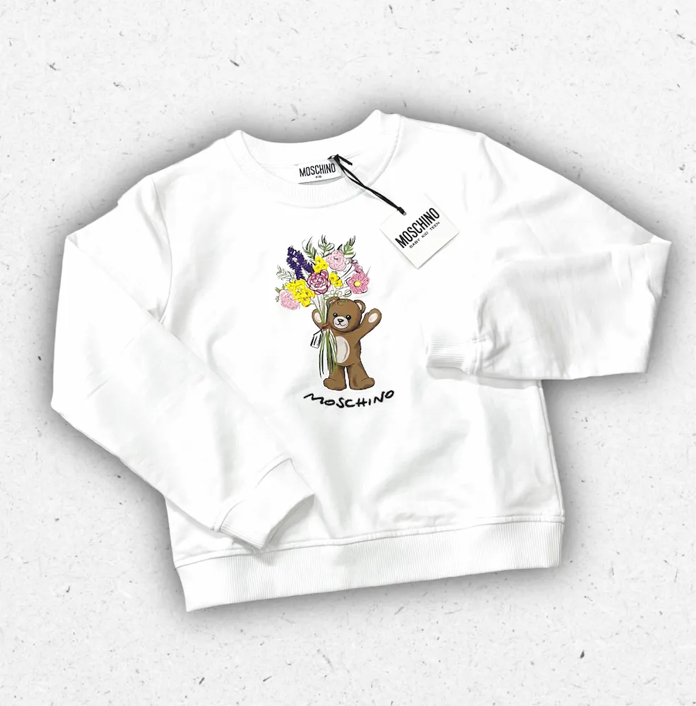 Felpa bianca da ragazza Moschino Kids con stampa frontale dell'iconico Teddy Bear e logo, realizzata in morbido cotone.