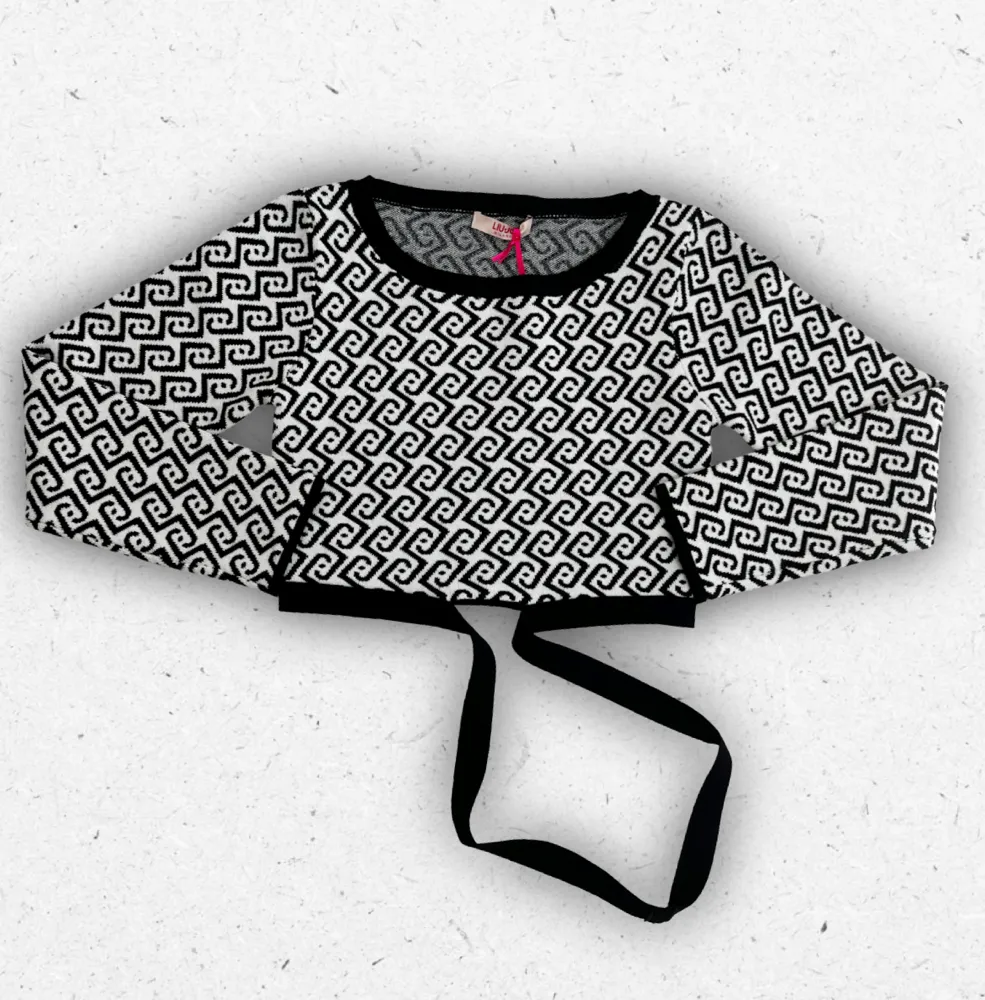 Maglia da ragazza Liu Jo con fantasia monogram bicolore bianco e nero, girocollo e vestibilità moderna.