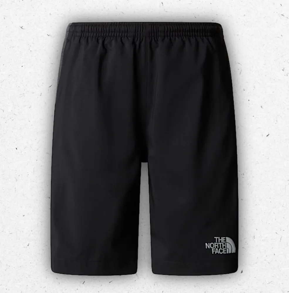 Pantaloncini tecnici da ragazzo The North Face 24/7 in tessuto traspirante FlashDry con logo riflettente, varianti nero e blu.