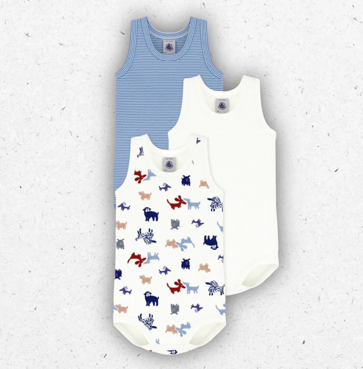 Tris di body per neonato Petit Bateau senza maniche in cotone a costine con fantasie millerighe e simpatici cani stampati.