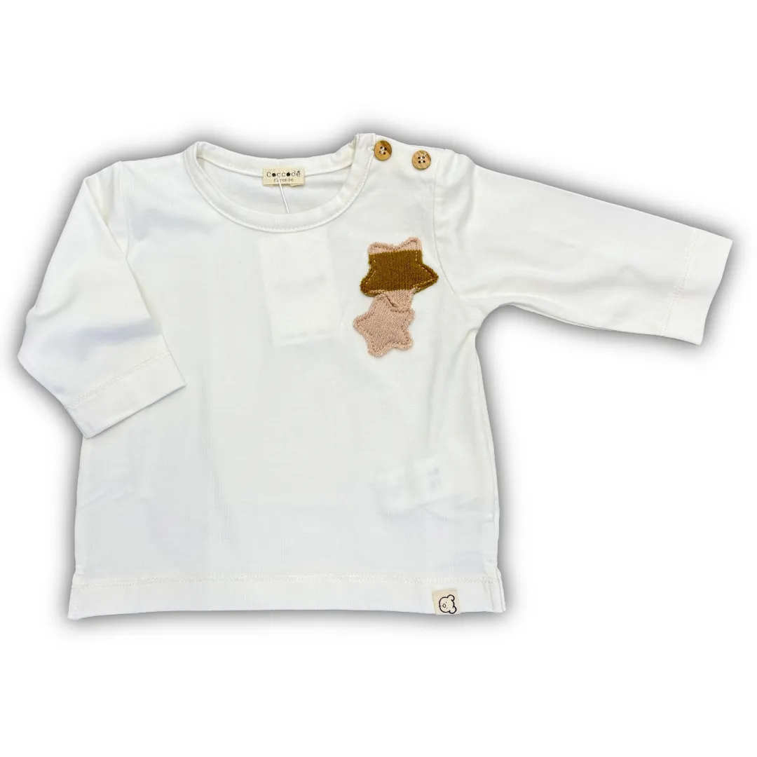 Maglia a manica lunga Coccodè per neonata, colore panna. Realizzata in morbido tessuto con applicazione a stella/animaletto in maglia sul petto.