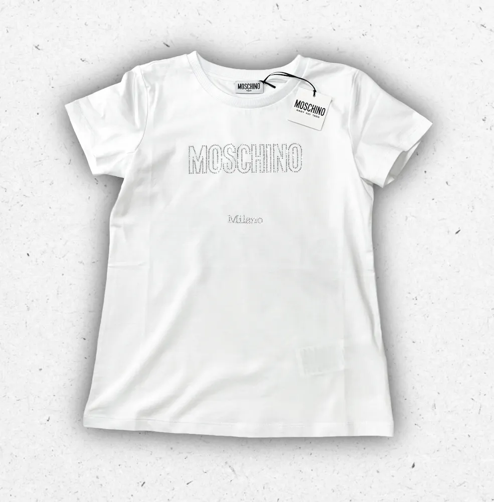 T-shirt bianca da ragazza Moschino in cotone con logo frontale brillantinato effetto sparkle.