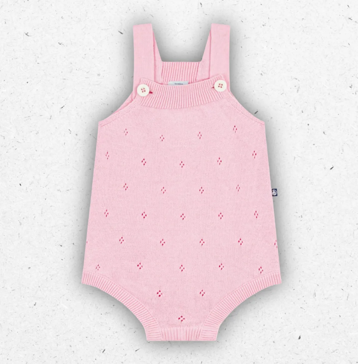Tutina corta per neonato Petit Bateau in maglia di cotone traforata, disponibile nei colori panna e rosa con apertura a pressione.